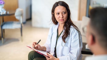 naltrexone: medical professional speaking to a patient 1786623660