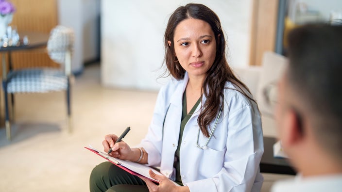 A medical professional speaks with a patient.