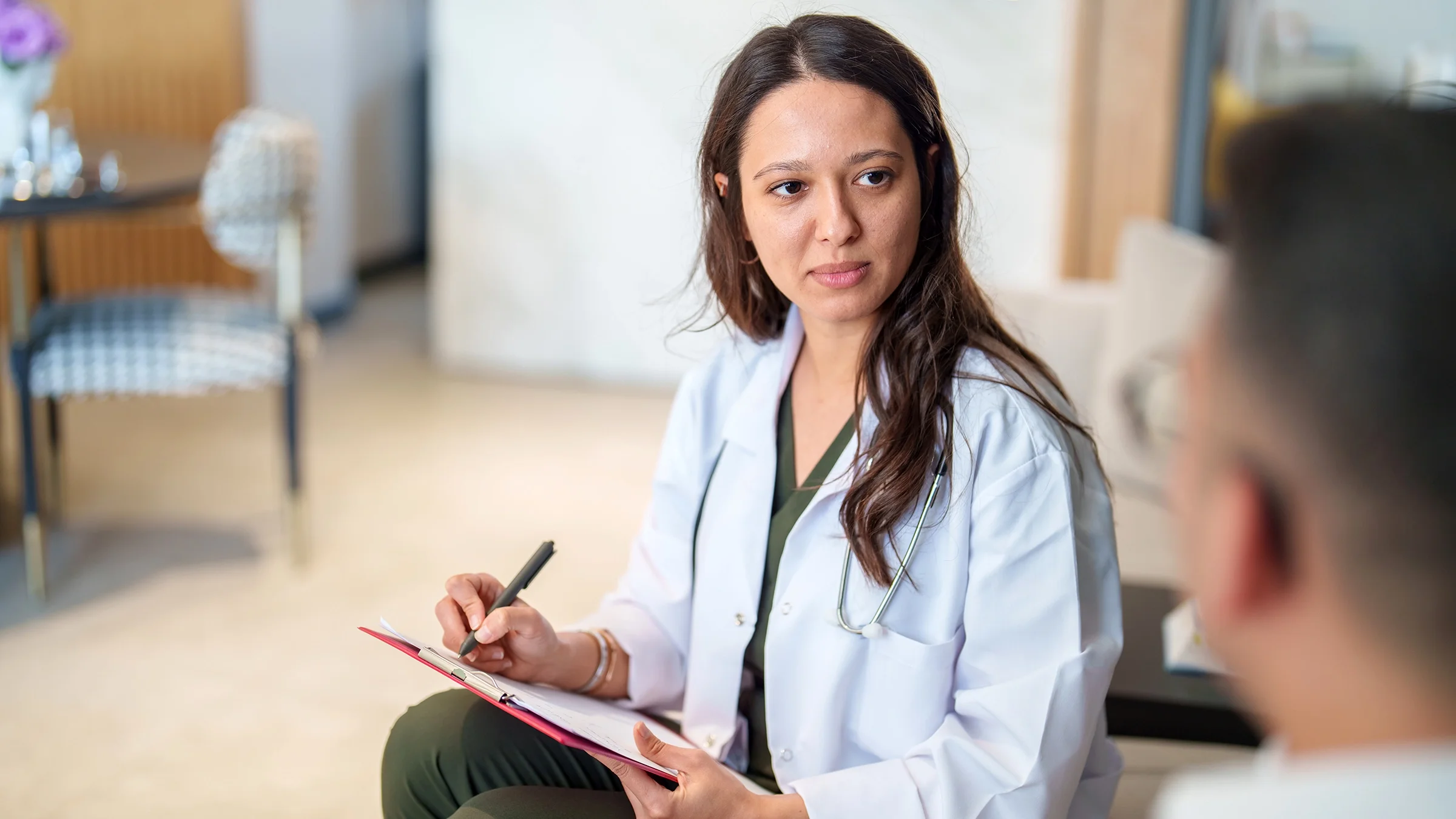 A medical professional speaks with a patient.