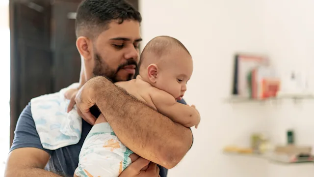Children's Health: man holding baby 1324105877