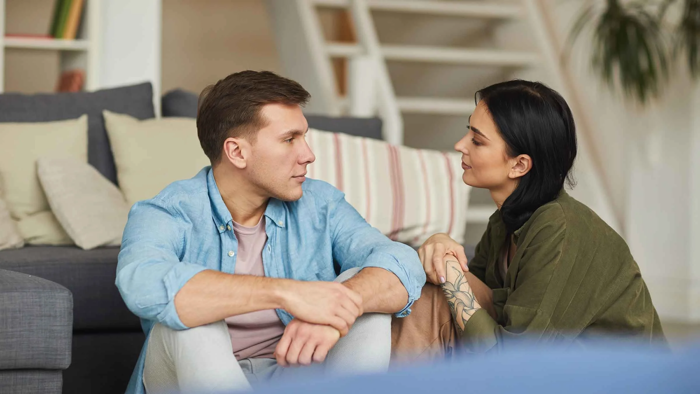 Couple engaged in conversation while sitting on floor