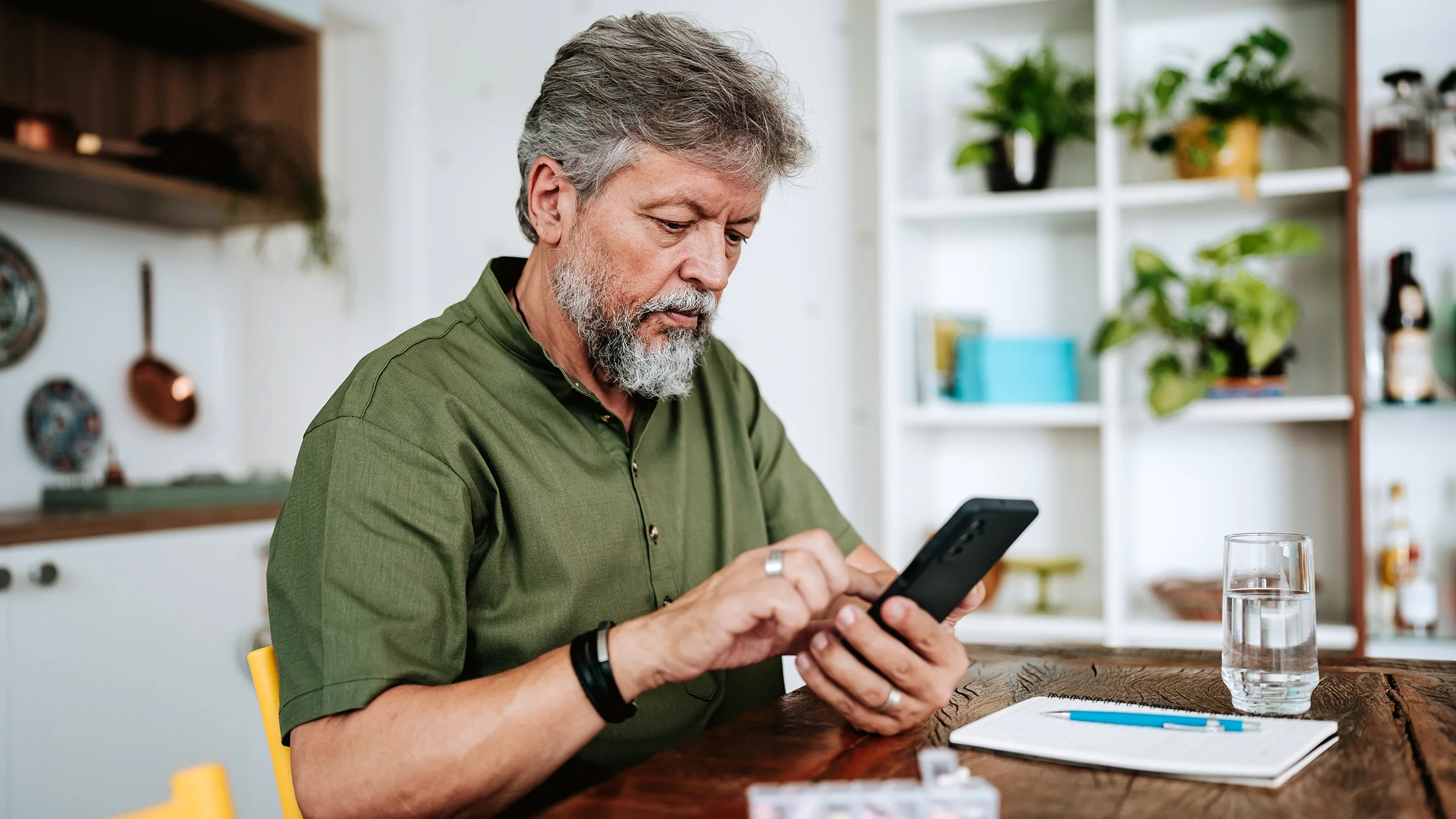 A man is looking up information about his prescription on his smartphone.