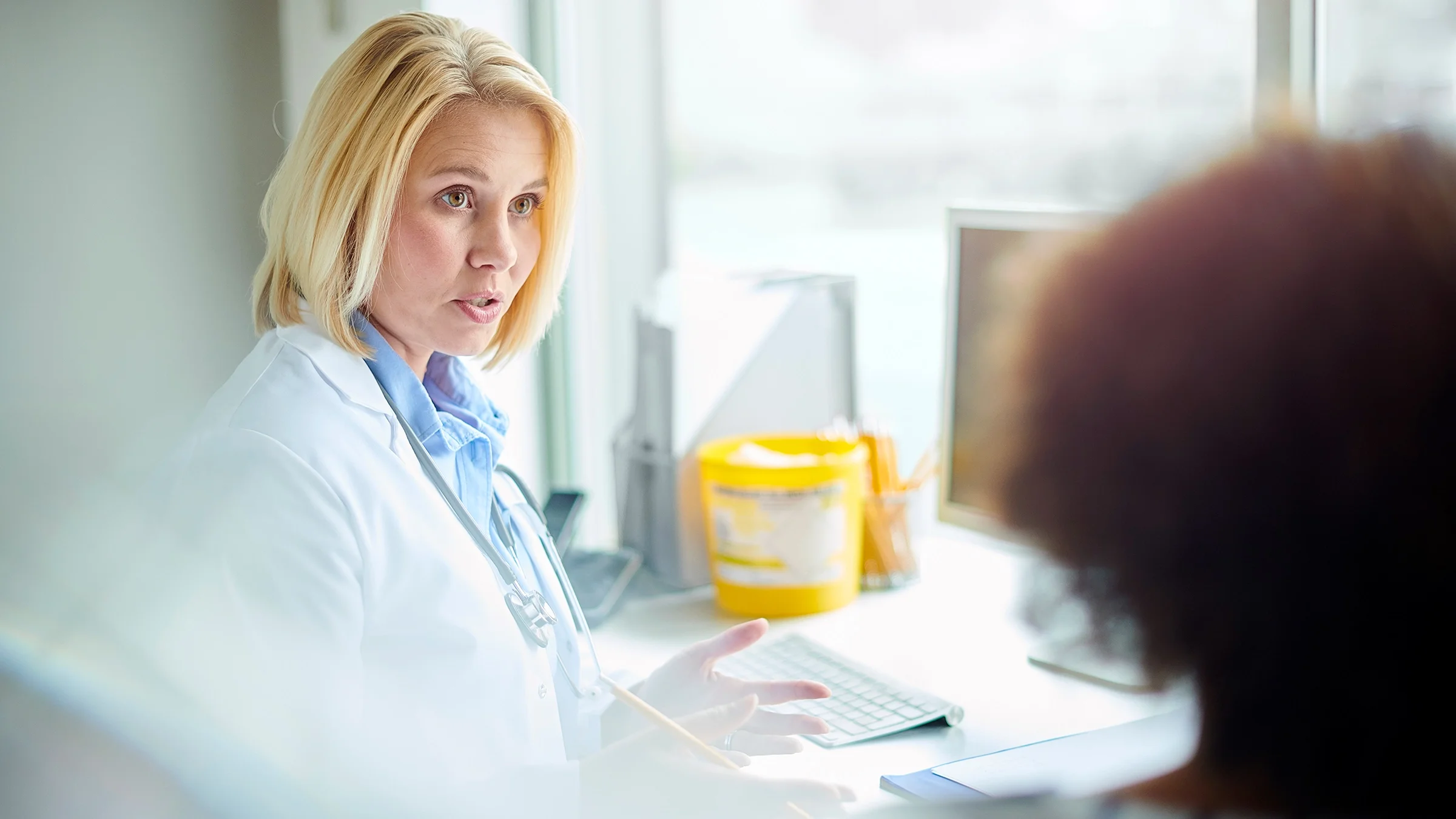A medical professional explains a treatment plan to a patient.