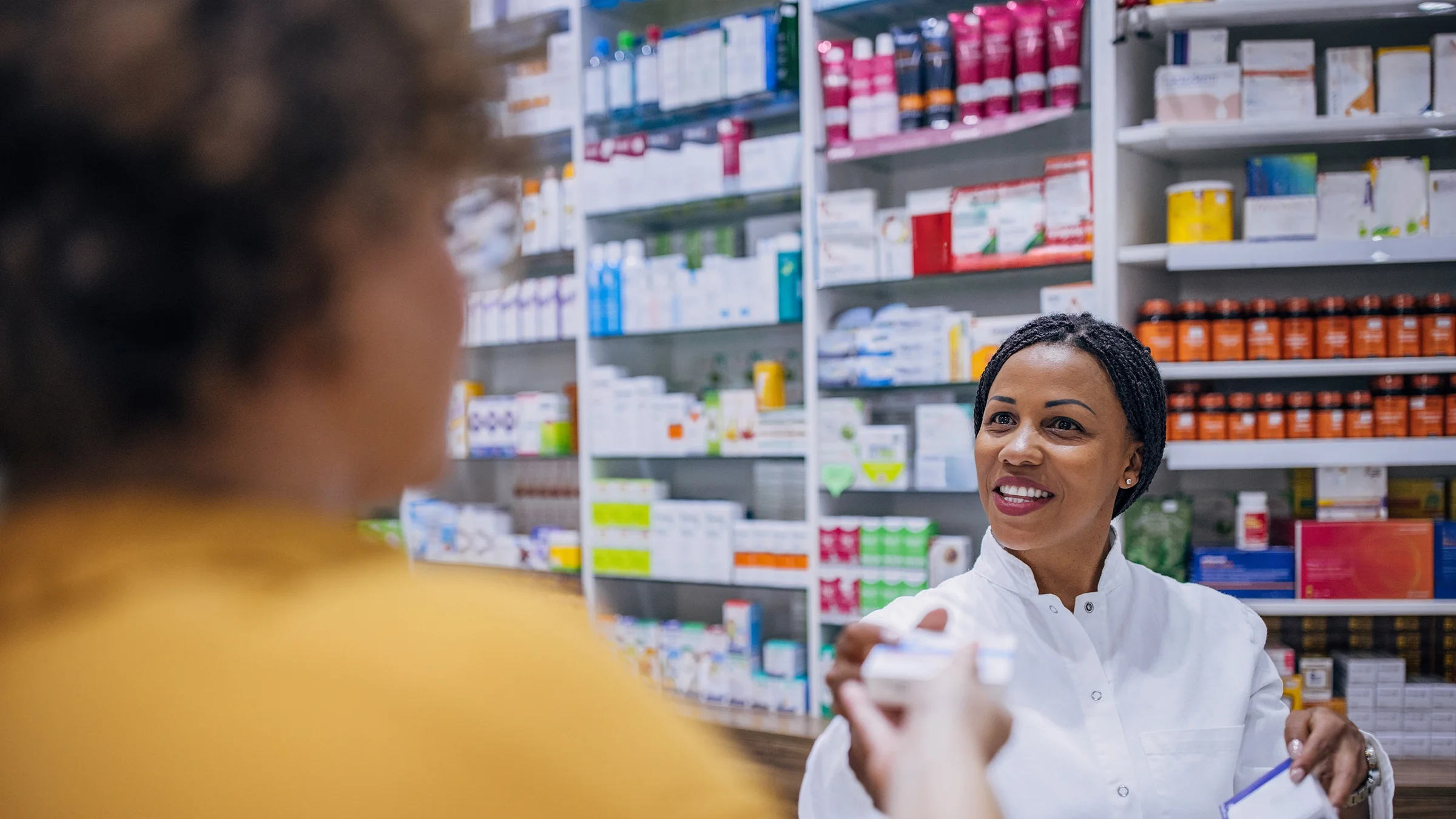A pharmacist speaks to a patient.