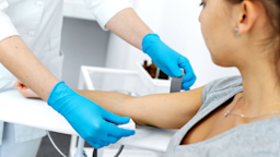A nurse, in close-up, prepares a patient’s vein for an injection.
Kateryna Kukota/iStock via Getty Images Plus