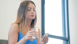 A person taking pills in the morning.
Igor Vershinsky/iStock via Getty Images Plus 