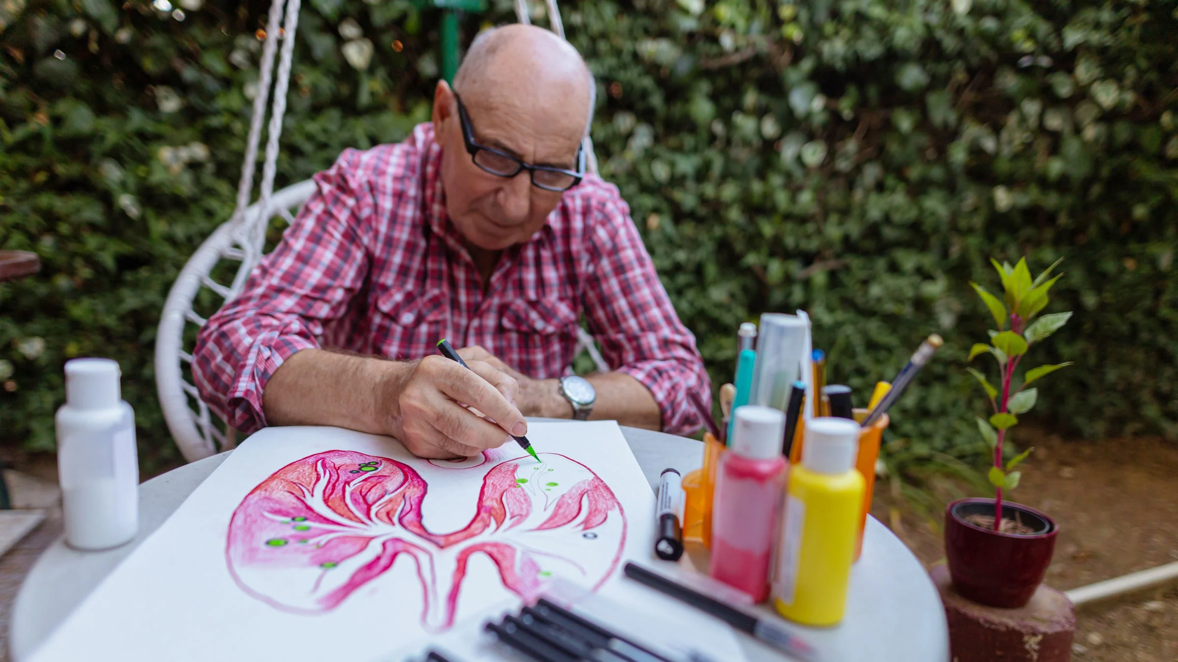 Man painting a picture of lungs for cancer awareness.