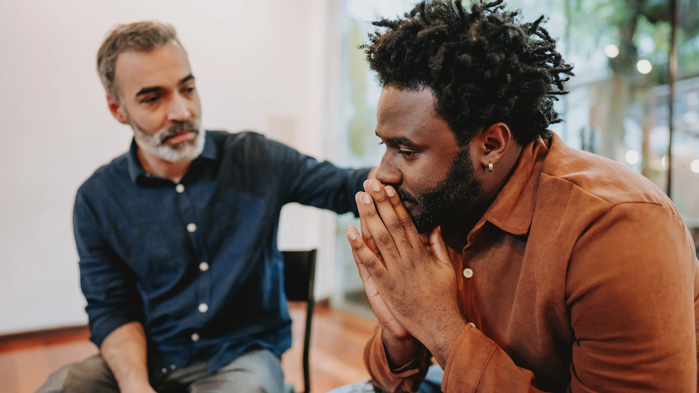 A man sits in contemplation during therapy.