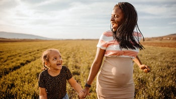 Pregnant: pregnant woman holds hand with her daughter 1391800384