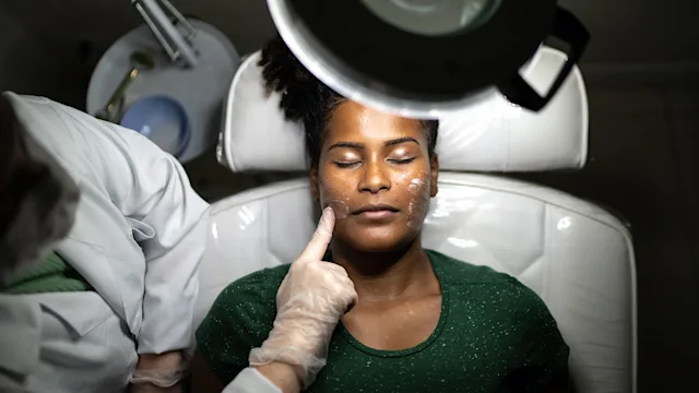 Dermatology: woman receiving facial treatment at the spa 1357513375
