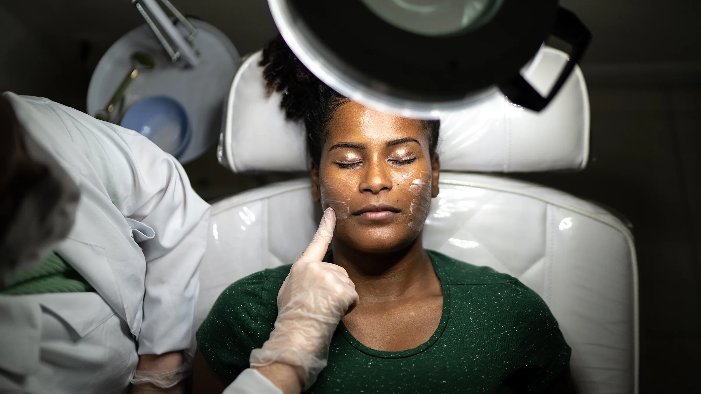 Woman receiving a facial treatment at a spa.