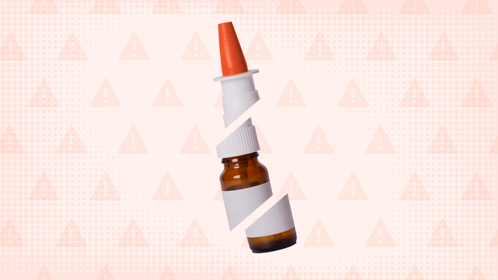 Light-red background with texture and a warning sign pattern. In the center is a nasal spray bottle with a red cap cut into thirds.