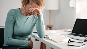 Promethazine: Interactions: older woman stomach pain at desk 1348082521