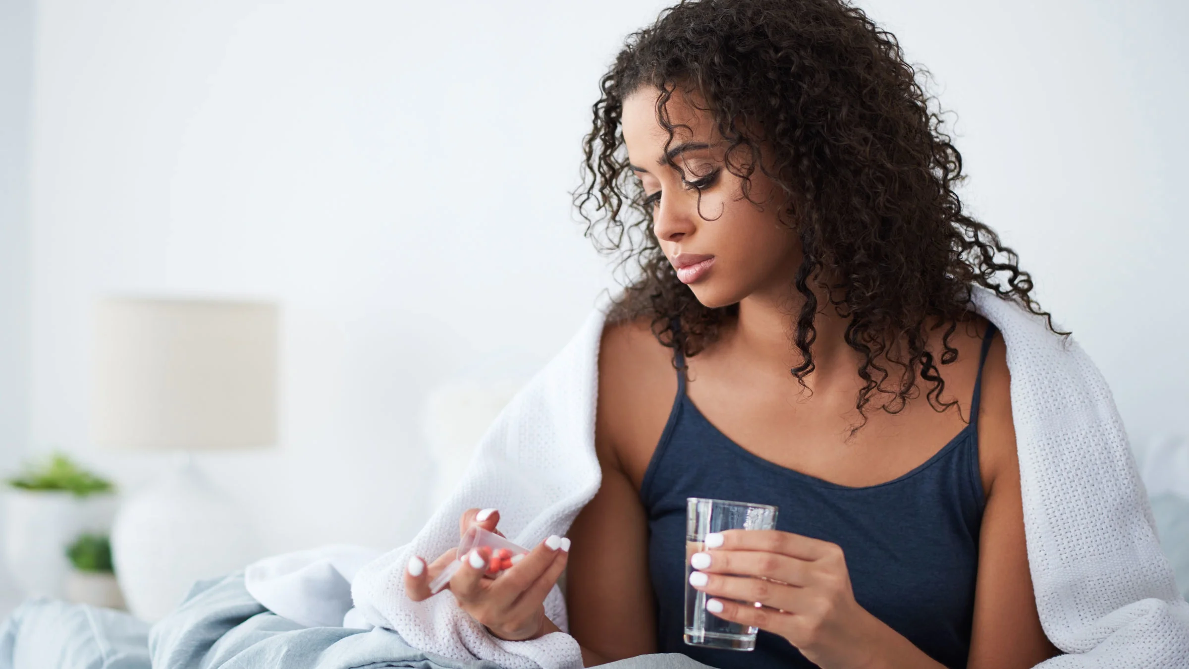 A woman takes morning medication. 