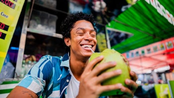diet-nutrition: man drinking coconut water 2174605534