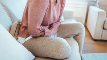Health: Tamiflu: cropped shot woman grasping stomach-1382291597