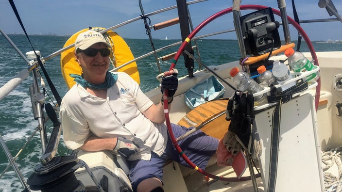 Mike Larson at the helm of a friend’s sailboat on Biscayne Bay in Miami, Florida.