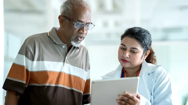 Medicare: HCP explains diagnosis with digital tablet 2149601986
