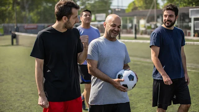 Musculoskeletal: men walking off of soccer field 1254992686