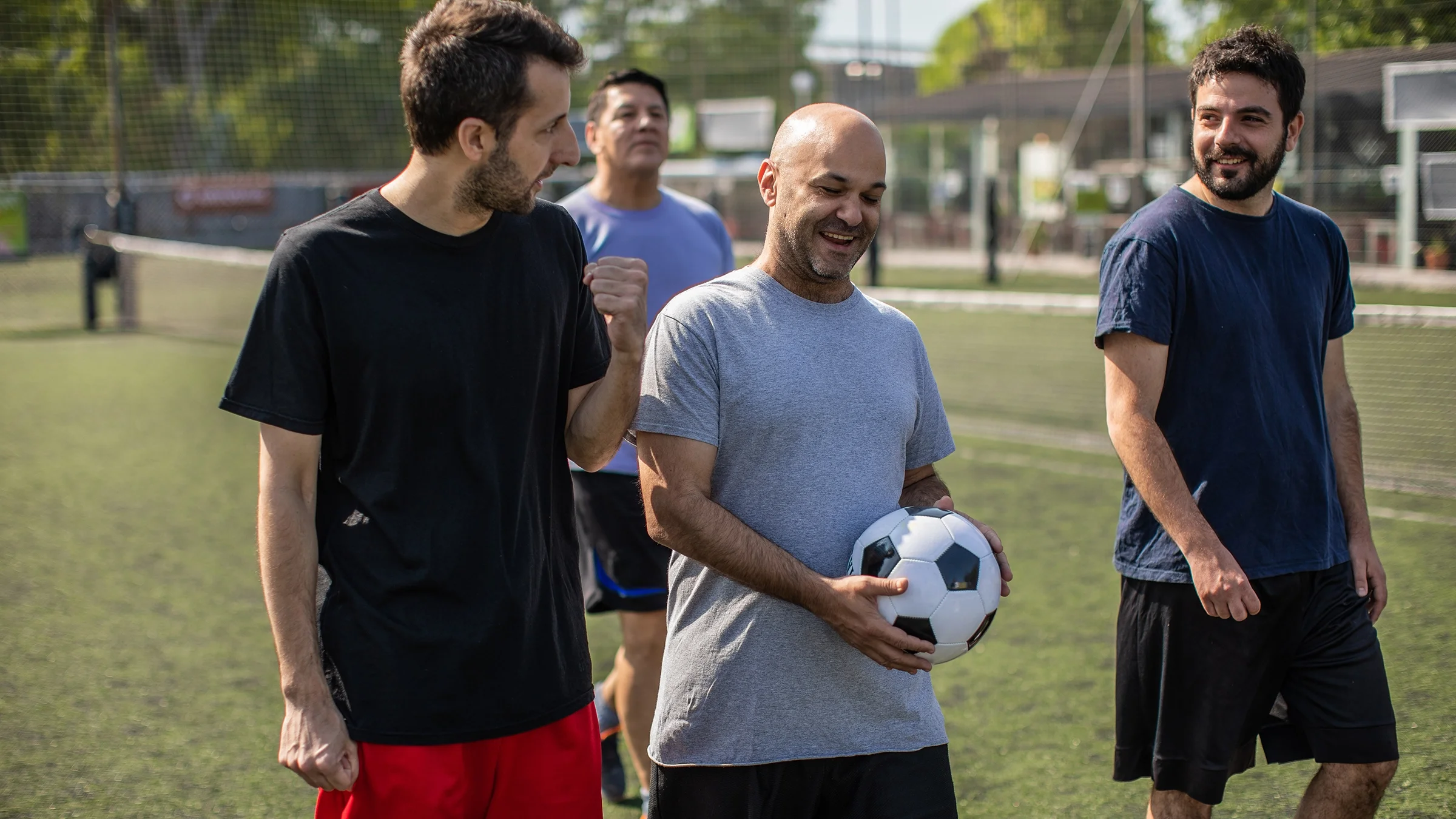 Men walking off the soccer field.