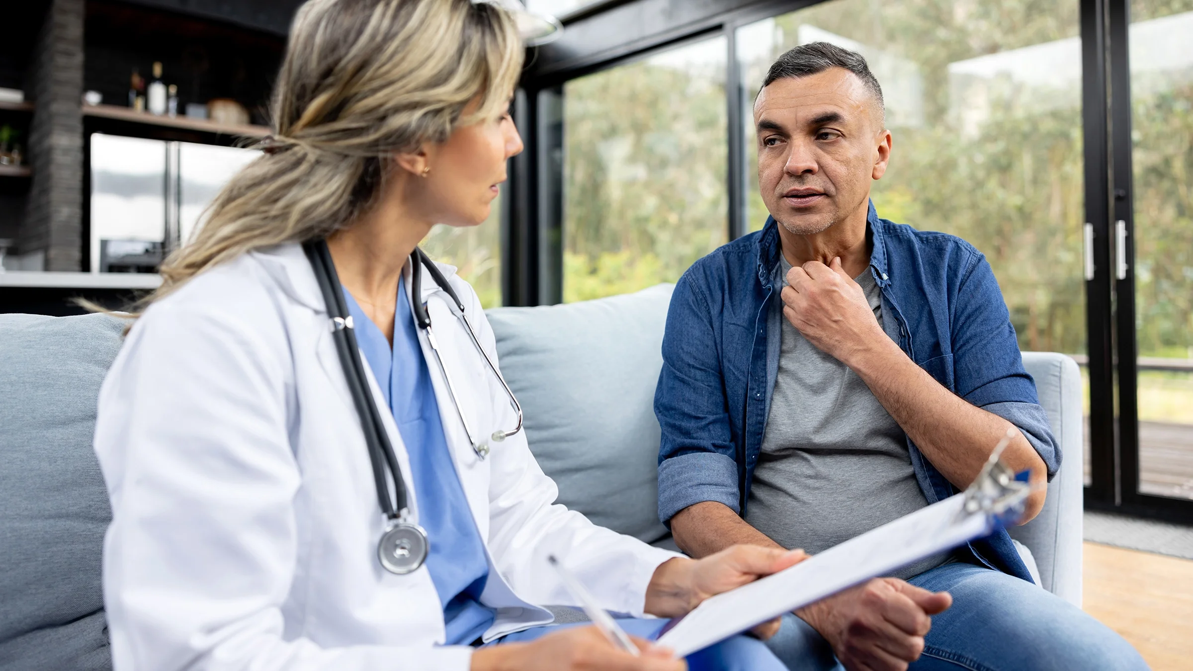 A man talks with a healthcare professional about his sore throat.