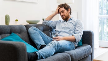 Health: Tizanidine: tired man on couch 1202528615