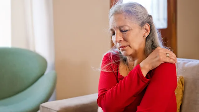 Menopause: woman with shoulder pain 1359360097