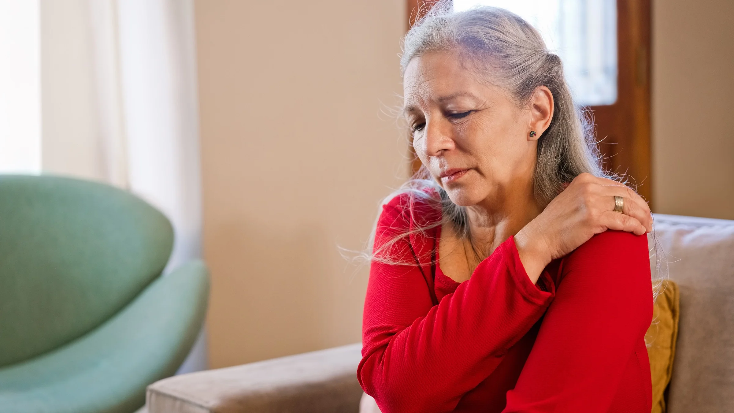 Woman suffering from shoulder pain.