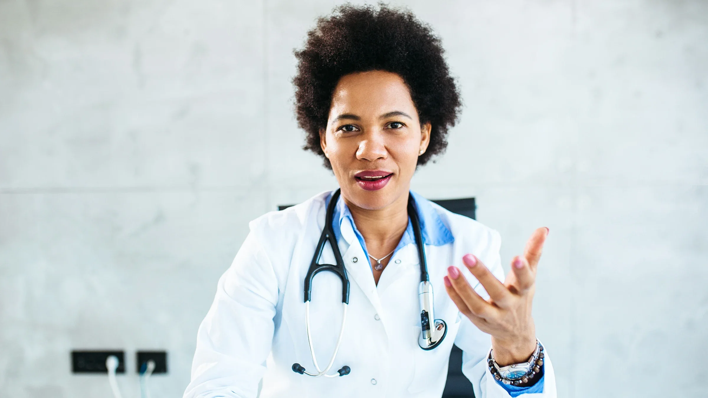 Portrait of a doctor talking directly to the camera.
momcilog/E+ via Getty Images