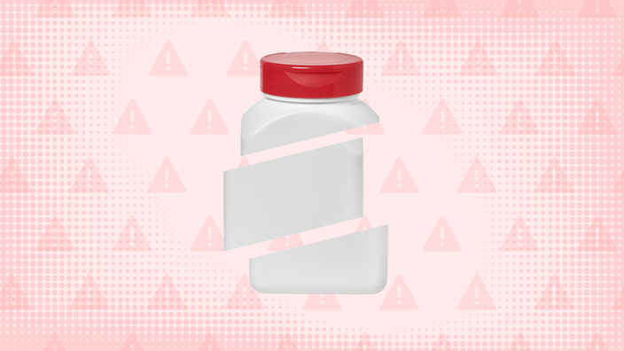 Light-red background with texture and warning sign pattern. In the center is a rectangular pill bottle, with a red cap, cut into thirds. 