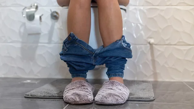 Constipation: cropped legs sitting on toilet 1124477677