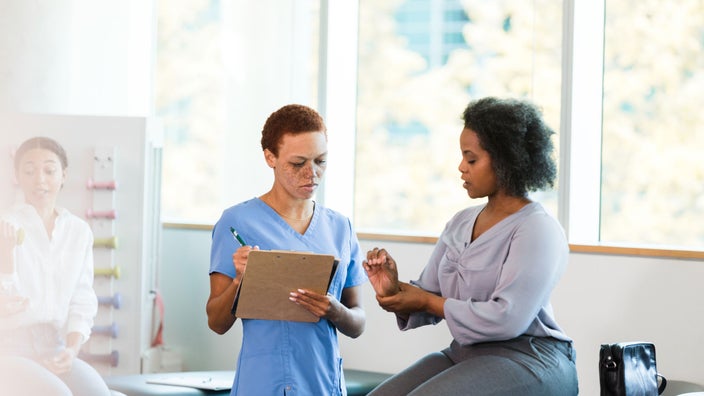Medical professional examines a patient's wrist.