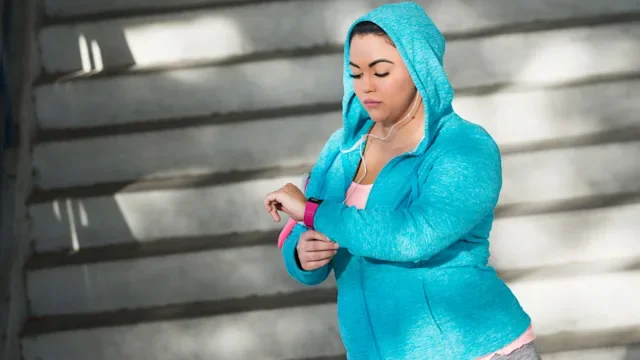 Movement exercise: looking at fitness tracker 679994132