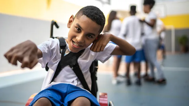 Spinal Muscular Atrophy: student in wheelchair sports court 1281045590