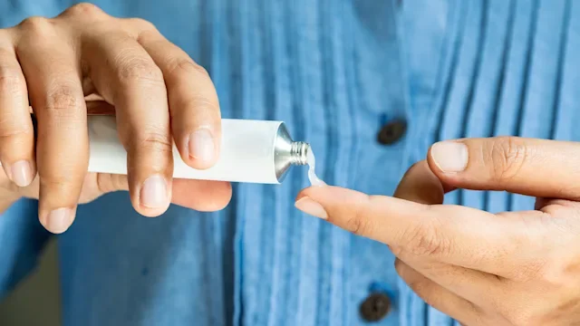 Pharmacy: closeup hands using rx cream 2200098555