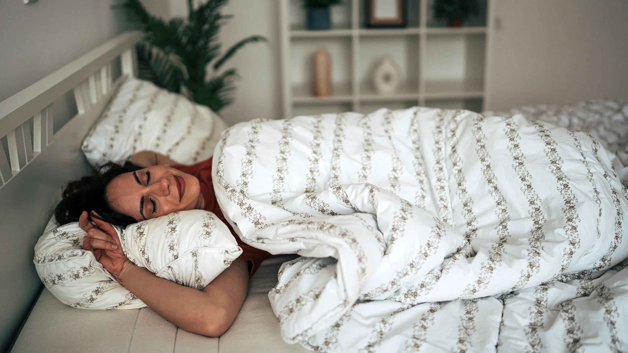 Woman sleeping under a white comforter
milorad kravic/E+ via Getty Images