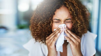 Health: montelukast: young woman blowing her nose 854418348