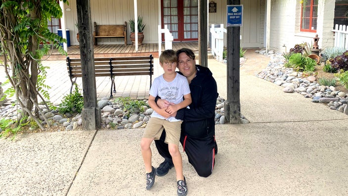 Blake LeVine pictured outside hugging his son.