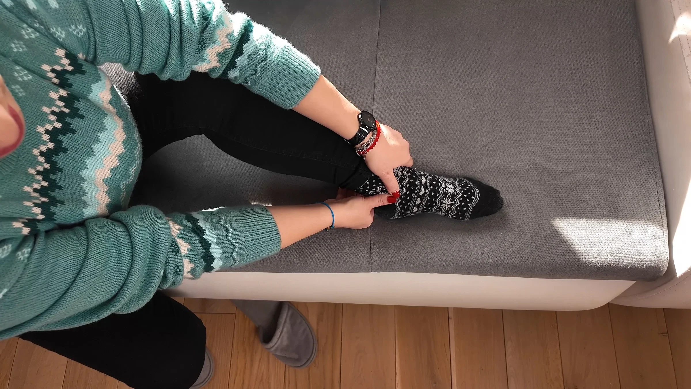 A woman rubs her ankle to relieve pain.