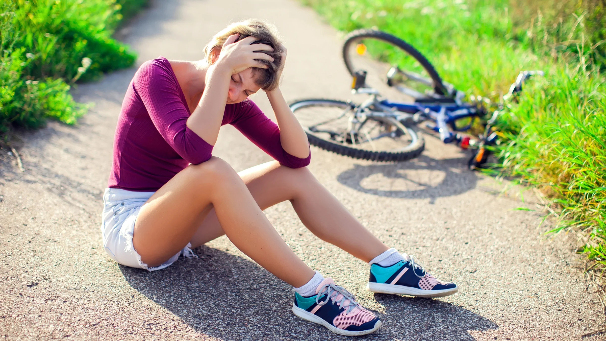 Woman with head injury after biking on bicycle.