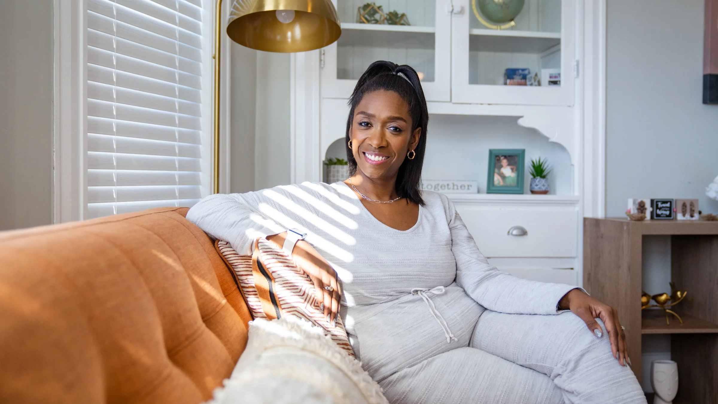 Portrait of Arelis Latorella sitting on a couch.