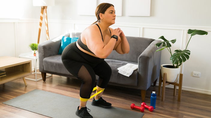 Woman using a resistance band while exercising.