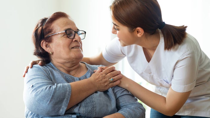 A HCP comforting a patient.