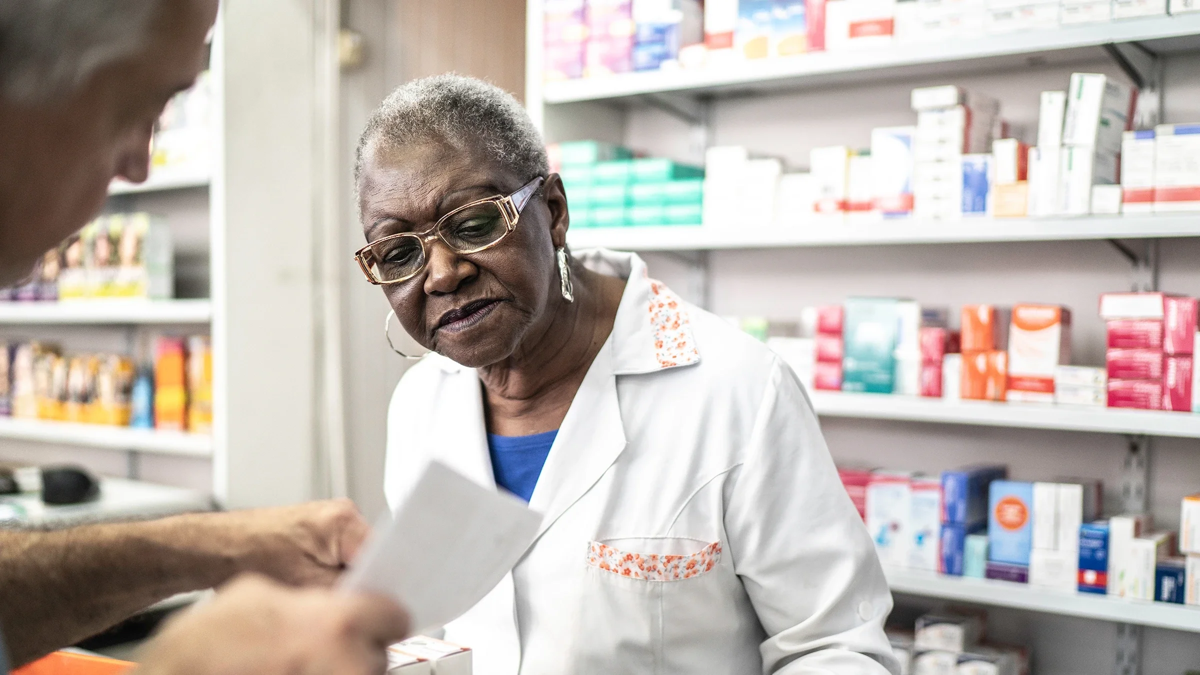 A pharmacist helps a customer.
