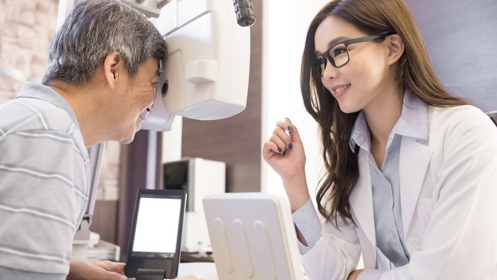 An older adult getting a vision exam.