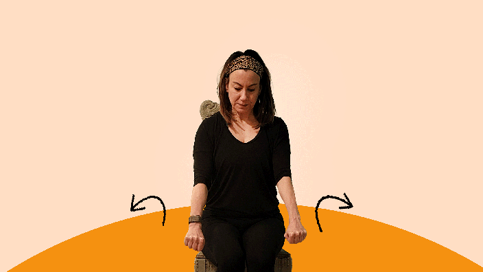 A woman does wrist circle exercises.