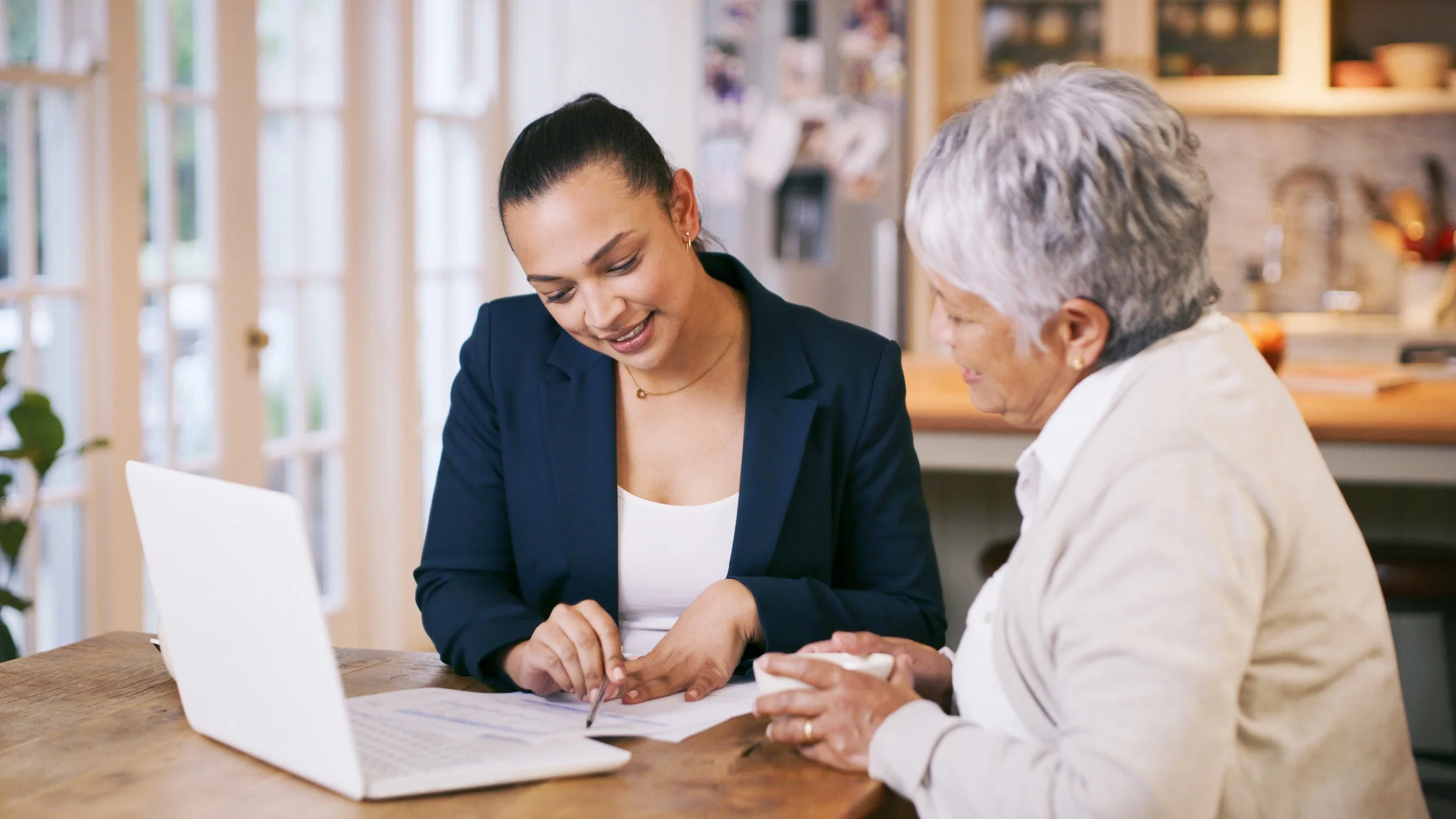 A financial advisor going through paperwork with a senior client.