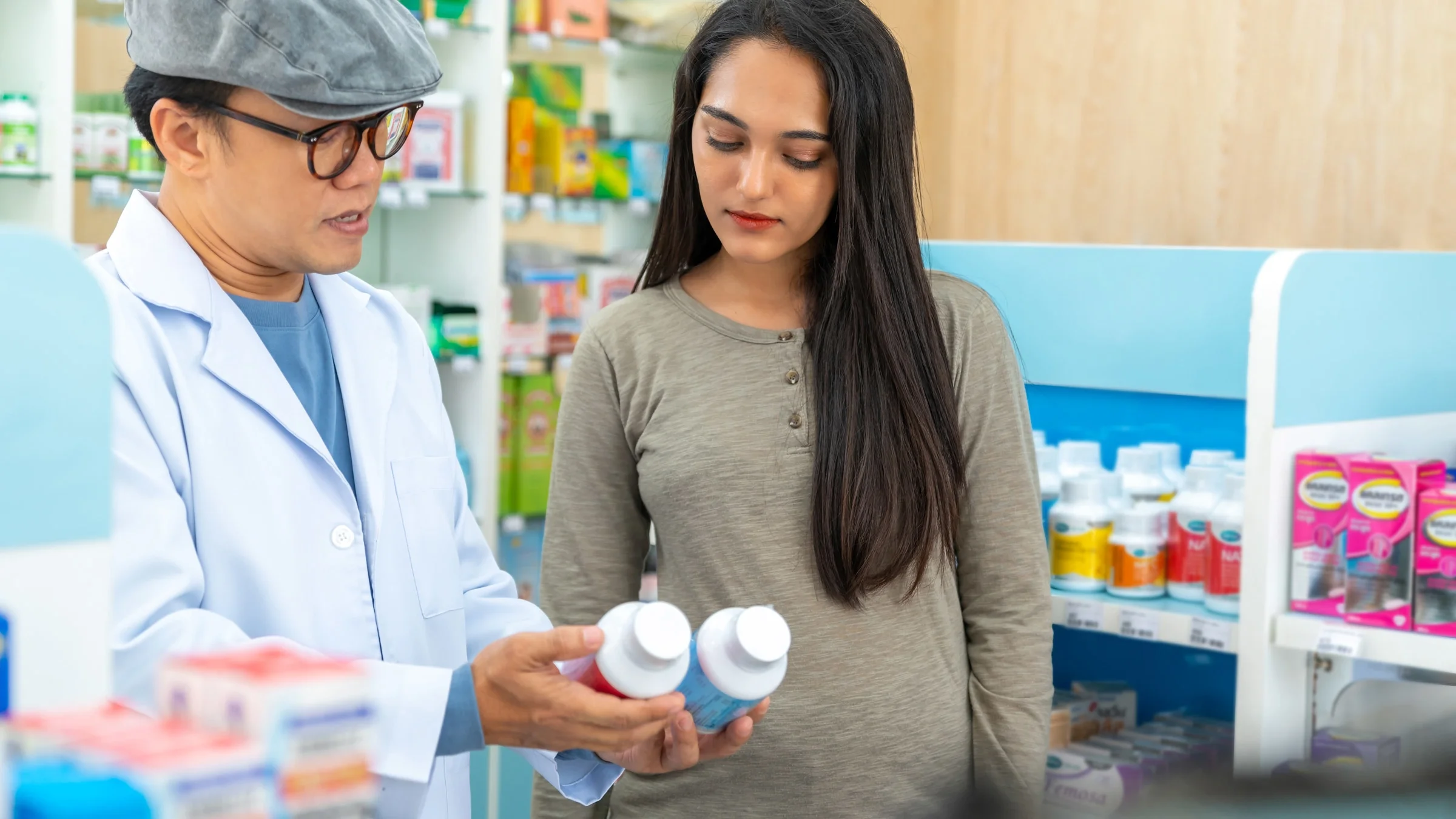 A pharmacist explaining supplements to customer.