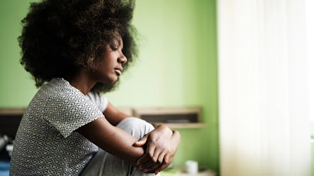 Health: Lupus: sad woman sitting on a bed 1204573522