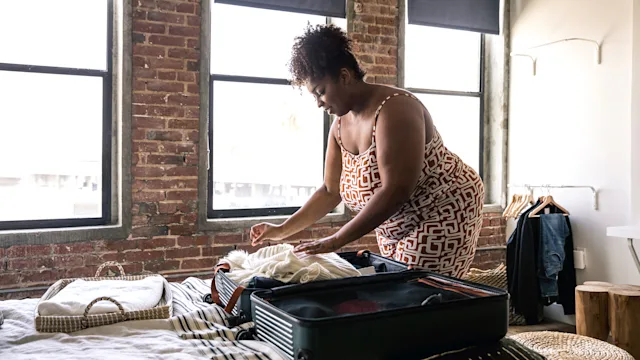 cannabis: woman packing a suitcase 1188655506